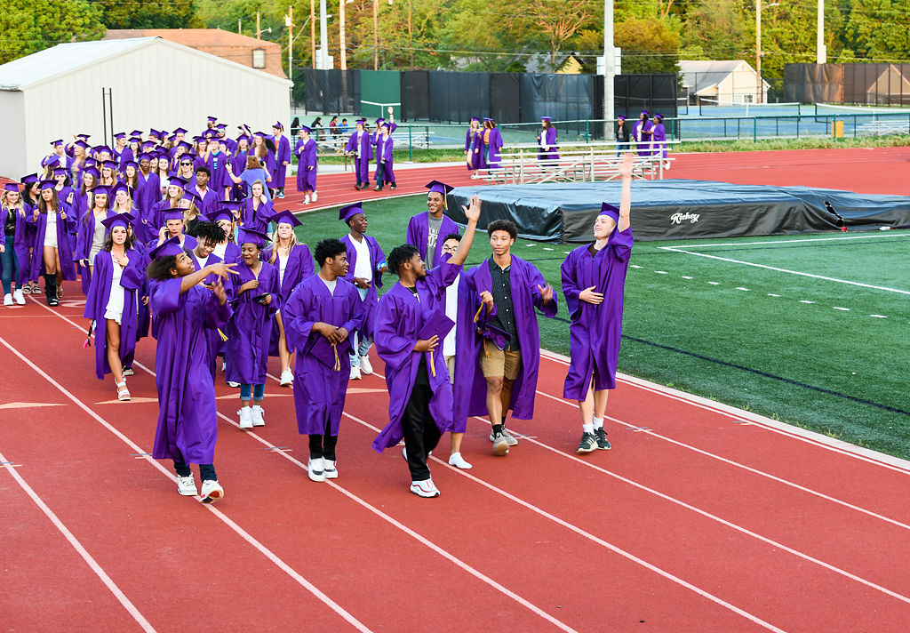 Hickman High School graduates take a lap around the track